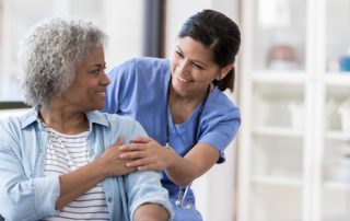 Family Nurse Practitioner engaging warmly with an elderly patient, providing comfort and support.