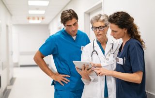 nurse practitioner and doctor looking at a clipboard