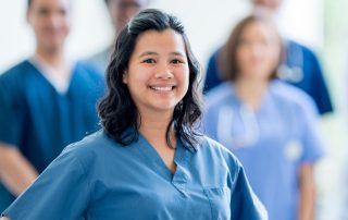 Portrait of Nurse Practitioner in front of team of nurses