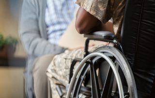 Veteran in a wheelchair talking to a man